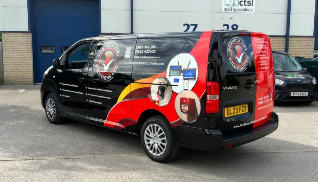 Norfolk Fire Solutions van parked outside a commercial building