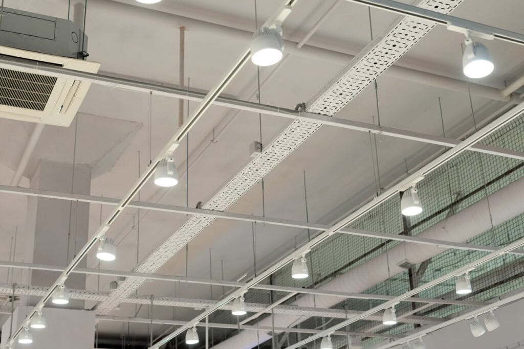 Installation of bright ceiling LED Lighting in a modern warehouse