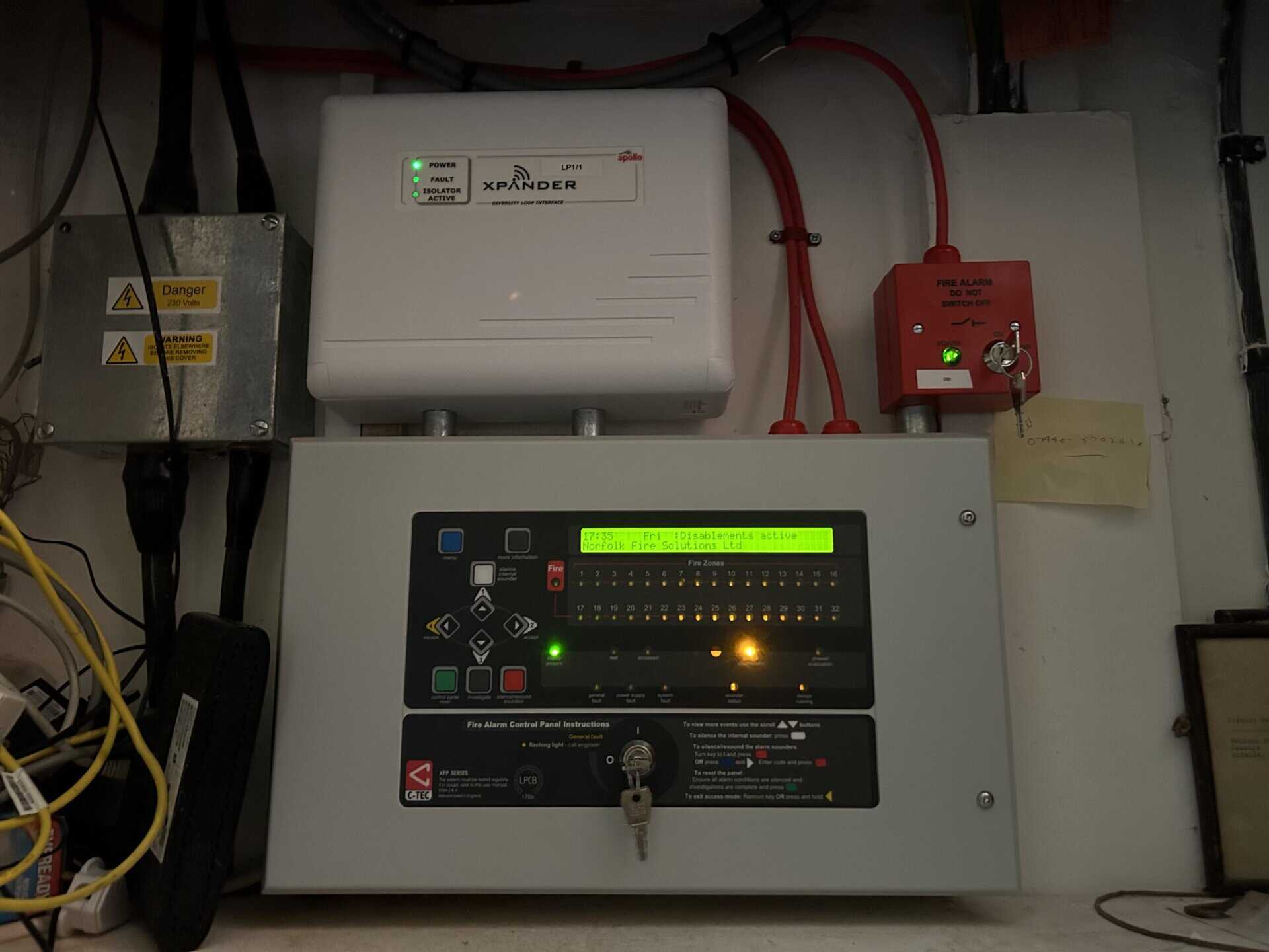 Fire alarm control panel with indicator lights.