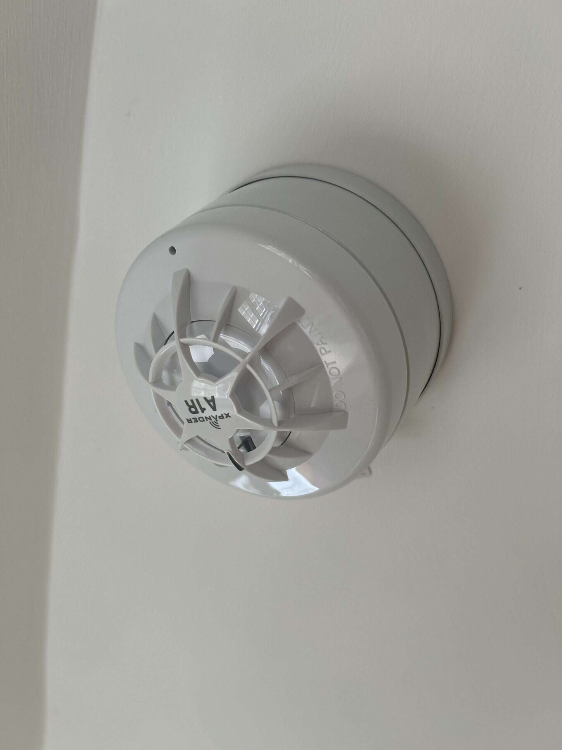 Ceiling mounted white smoke detector
