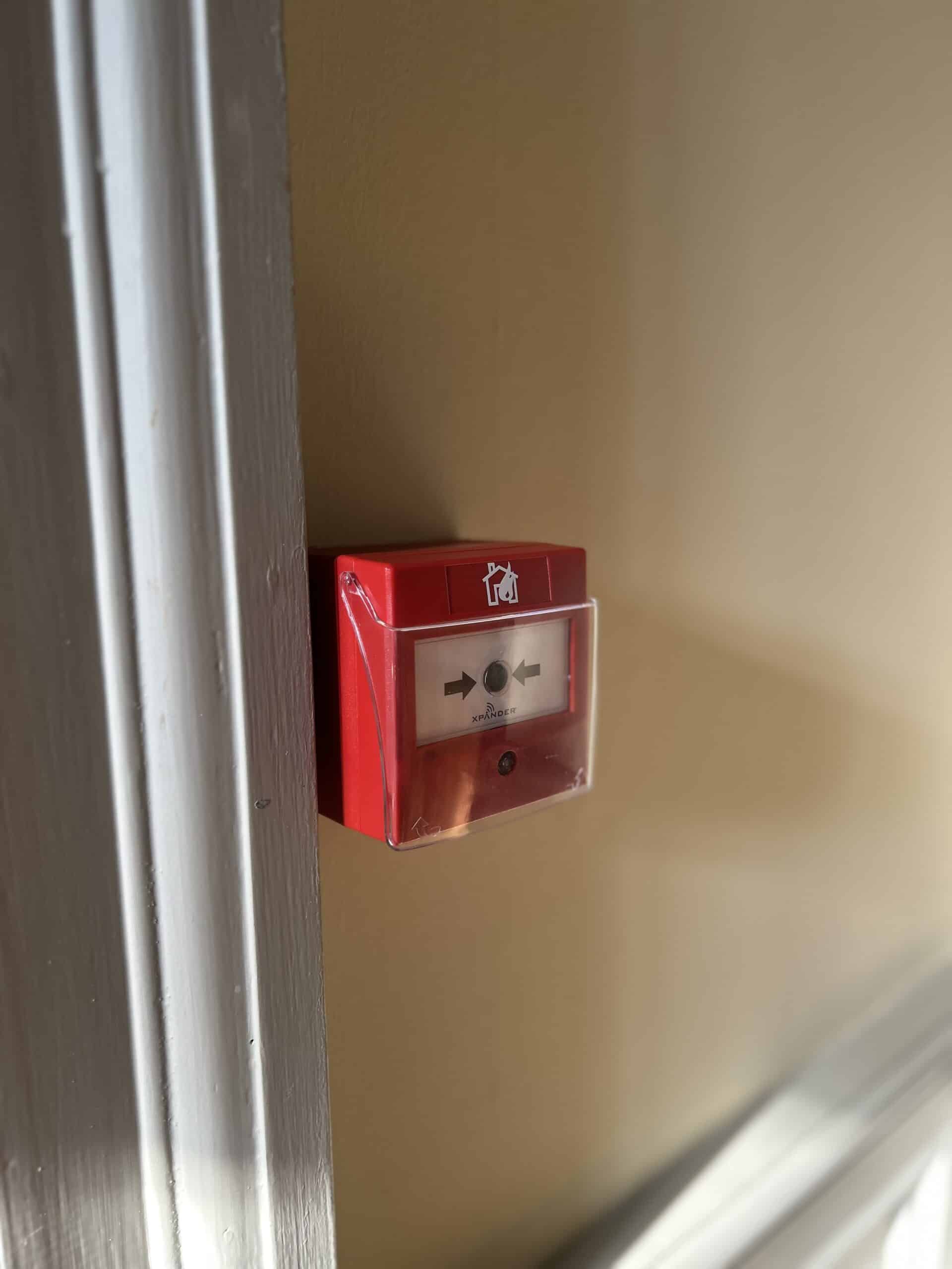 Red fire alarm box on wall indoors.