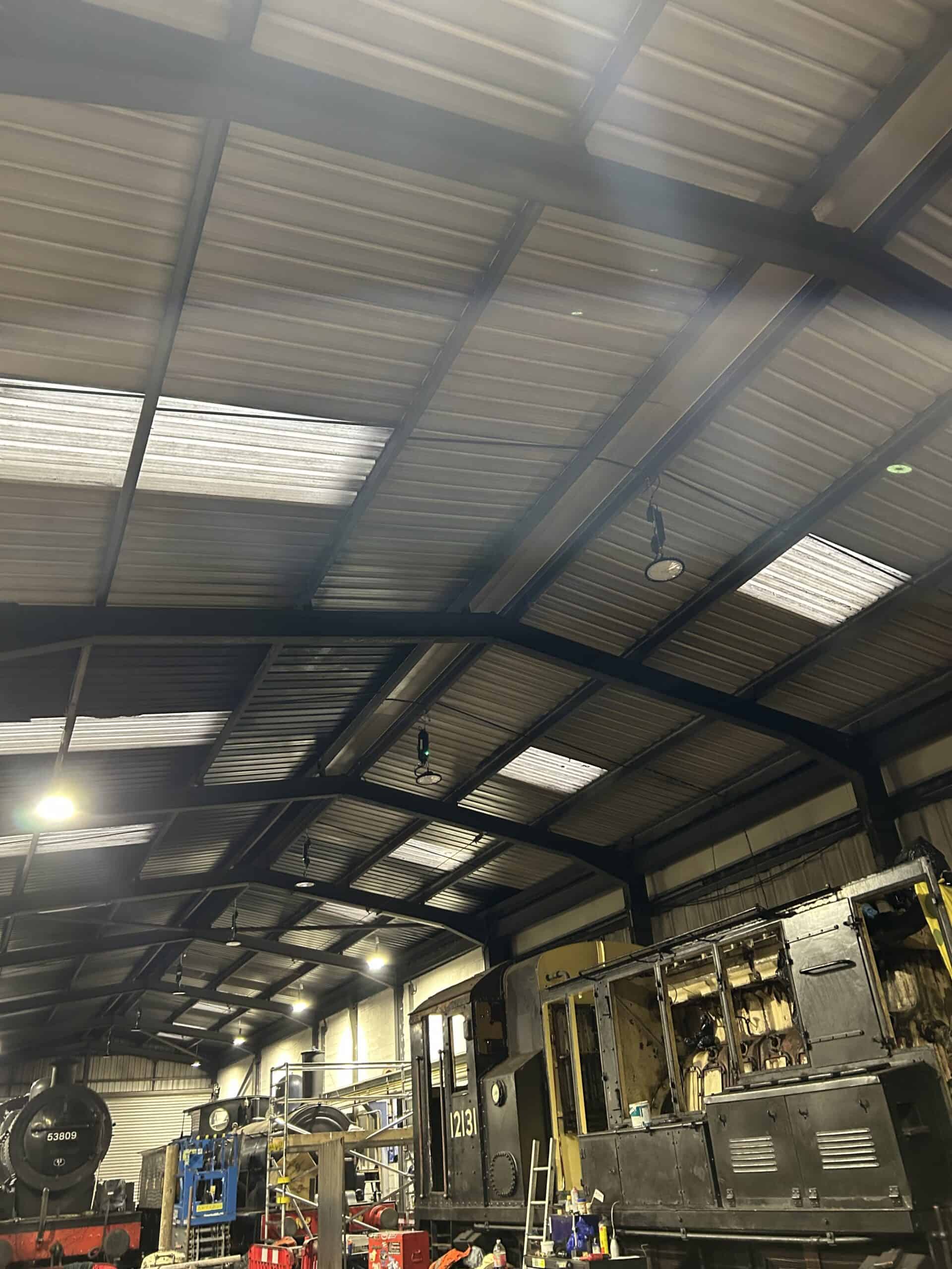 Interior of a workshop with locomotives being serviced.