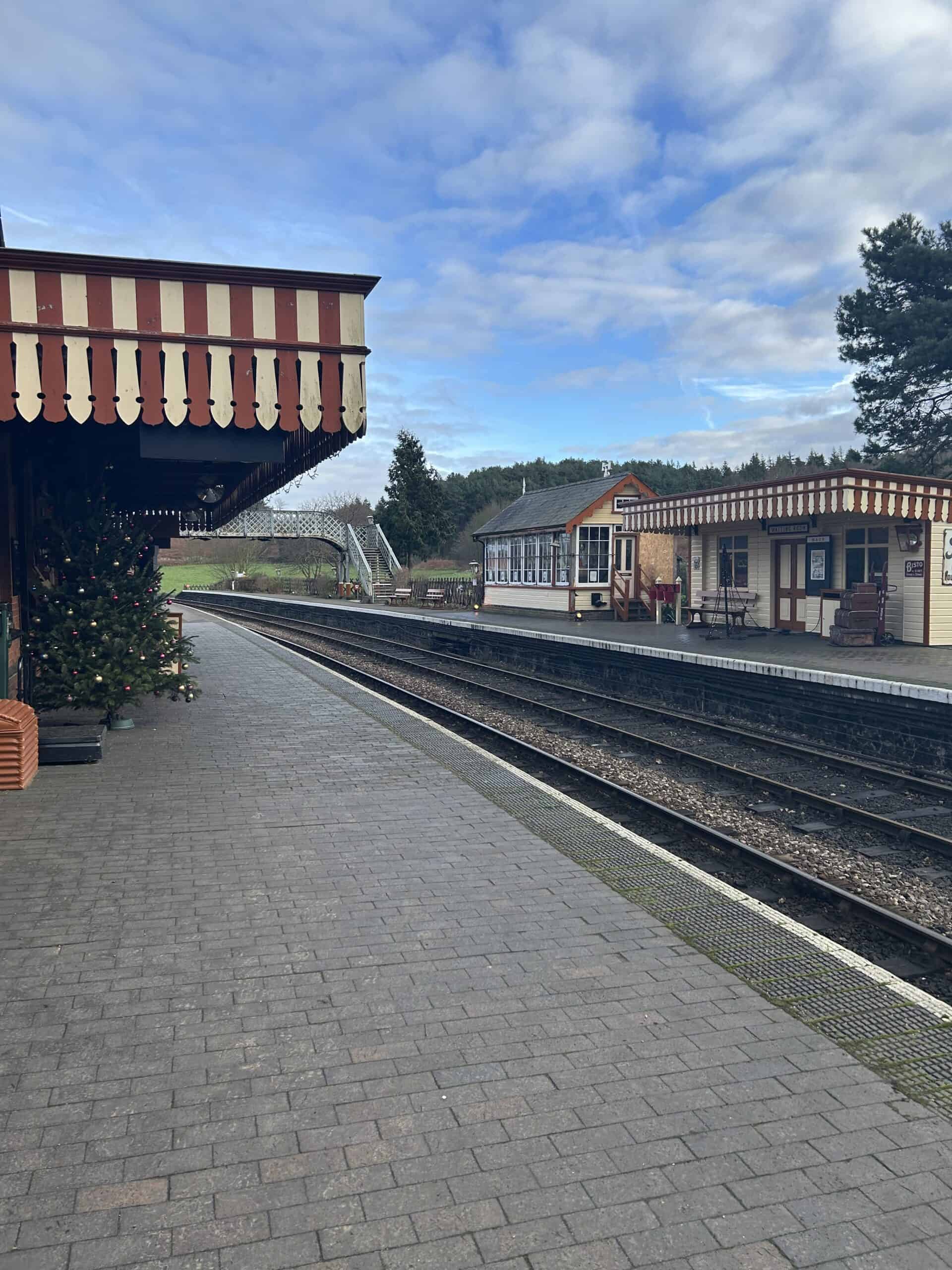 Quaint train station with festive decorations.