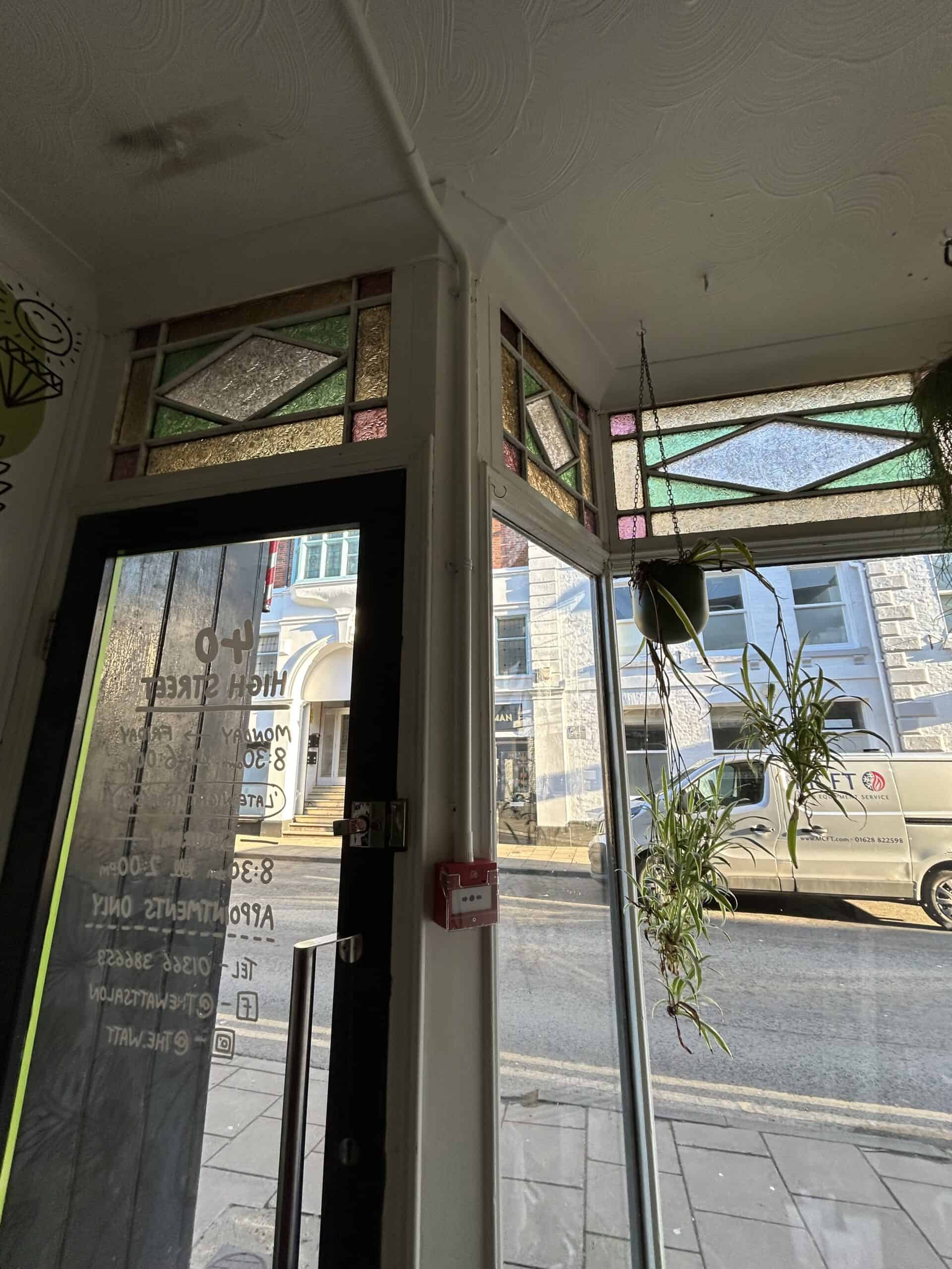 Inside view showing entrance and stained glass windows.