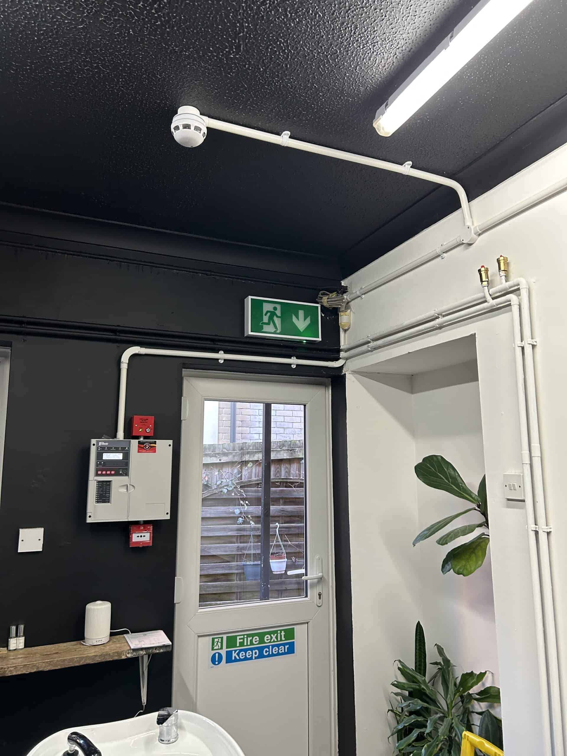 Interior view with fire exit and surveillance camera.