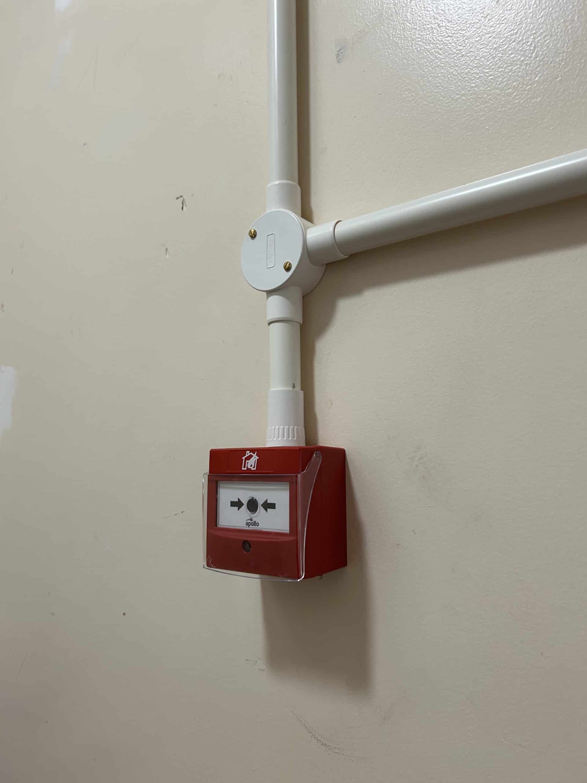 Red fire alarm control box on a wall