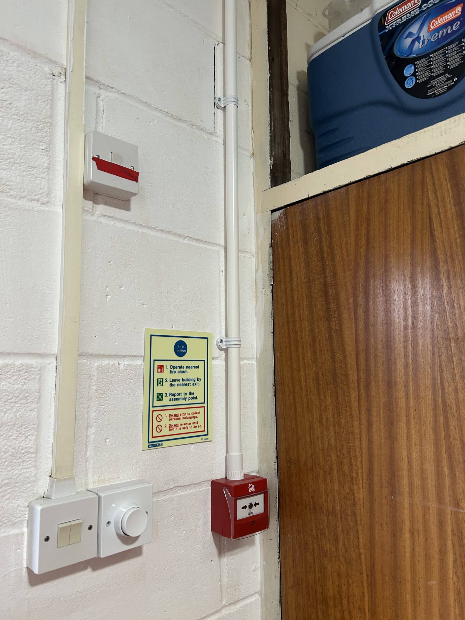 Fire alarm and safety instructions on wall