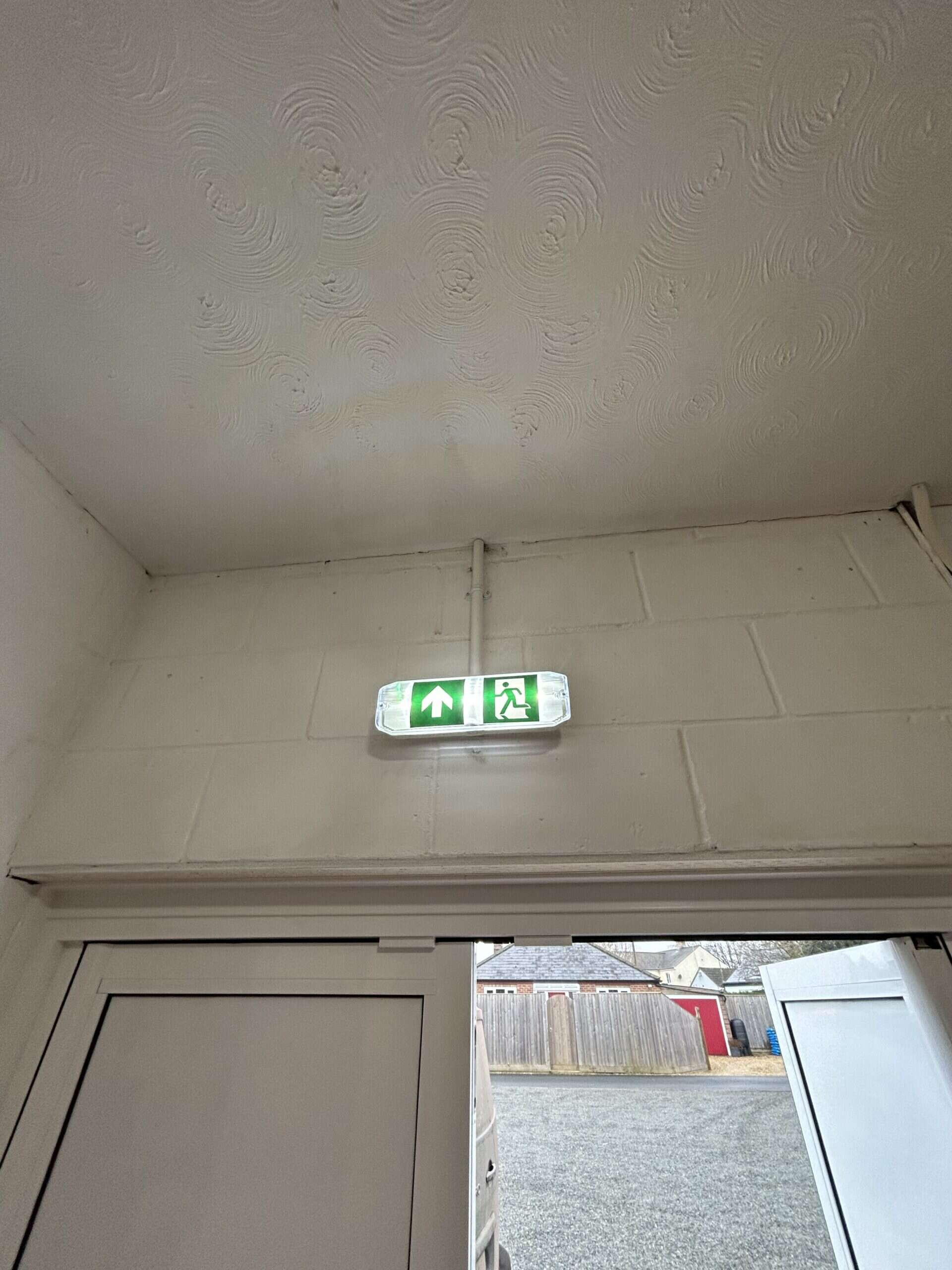 Emergency exit sign above an open door