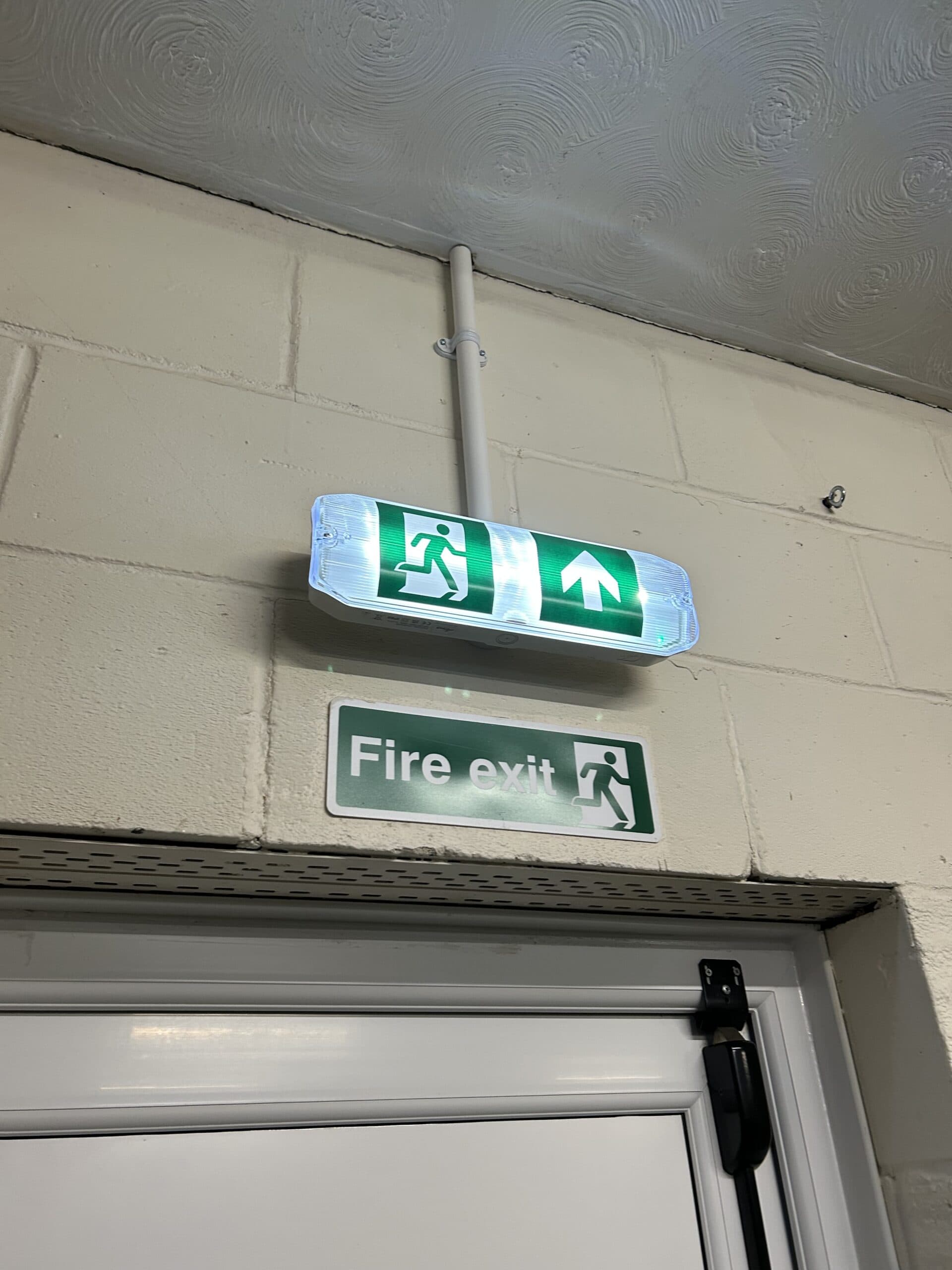Illuminated fire exit sign and indicator.